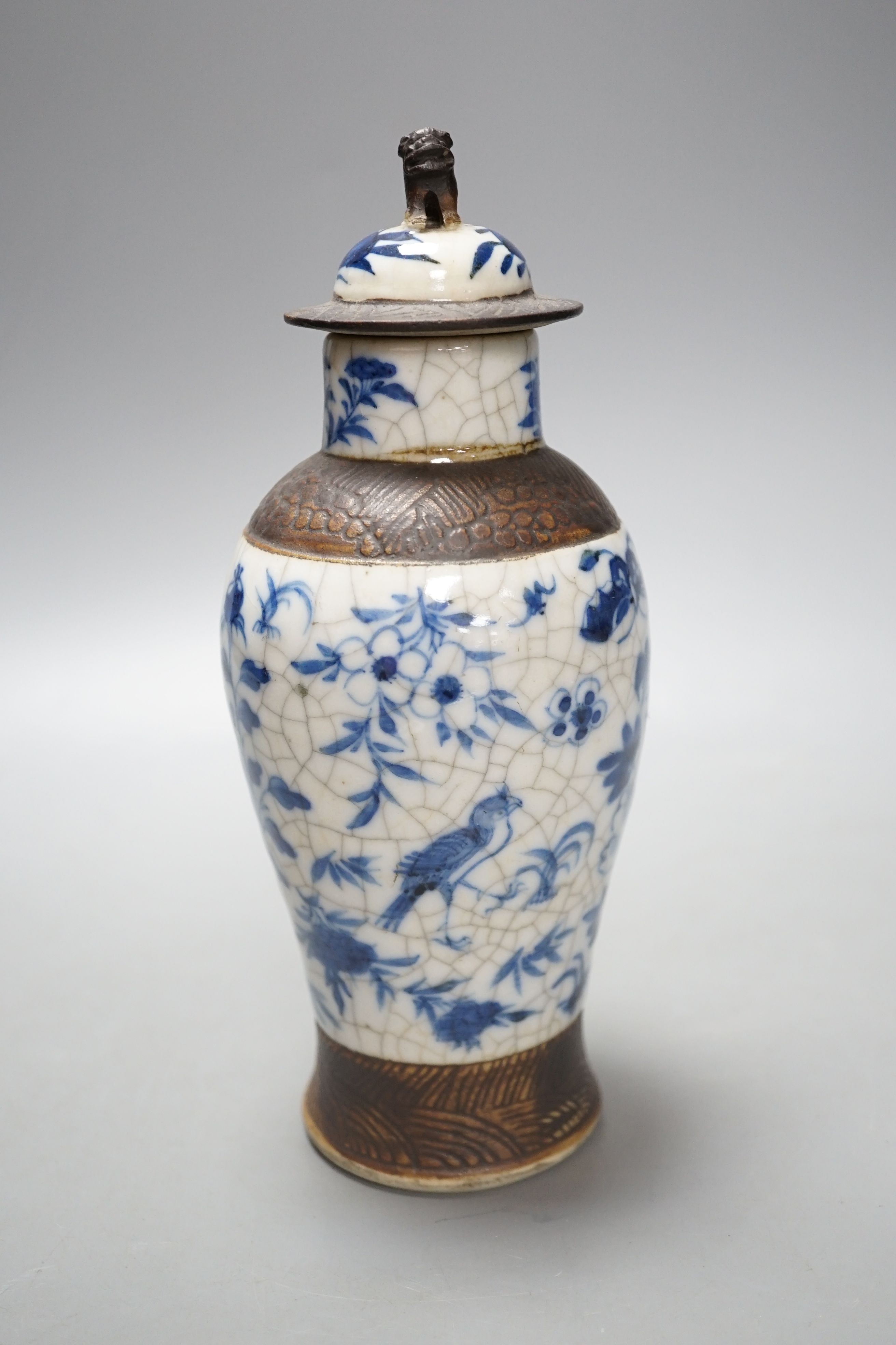 A Chinese blue and white crackle ware vase, c.1900, 22cms high including cover.